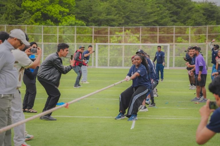 Students in a tug-of-war on a sports field
